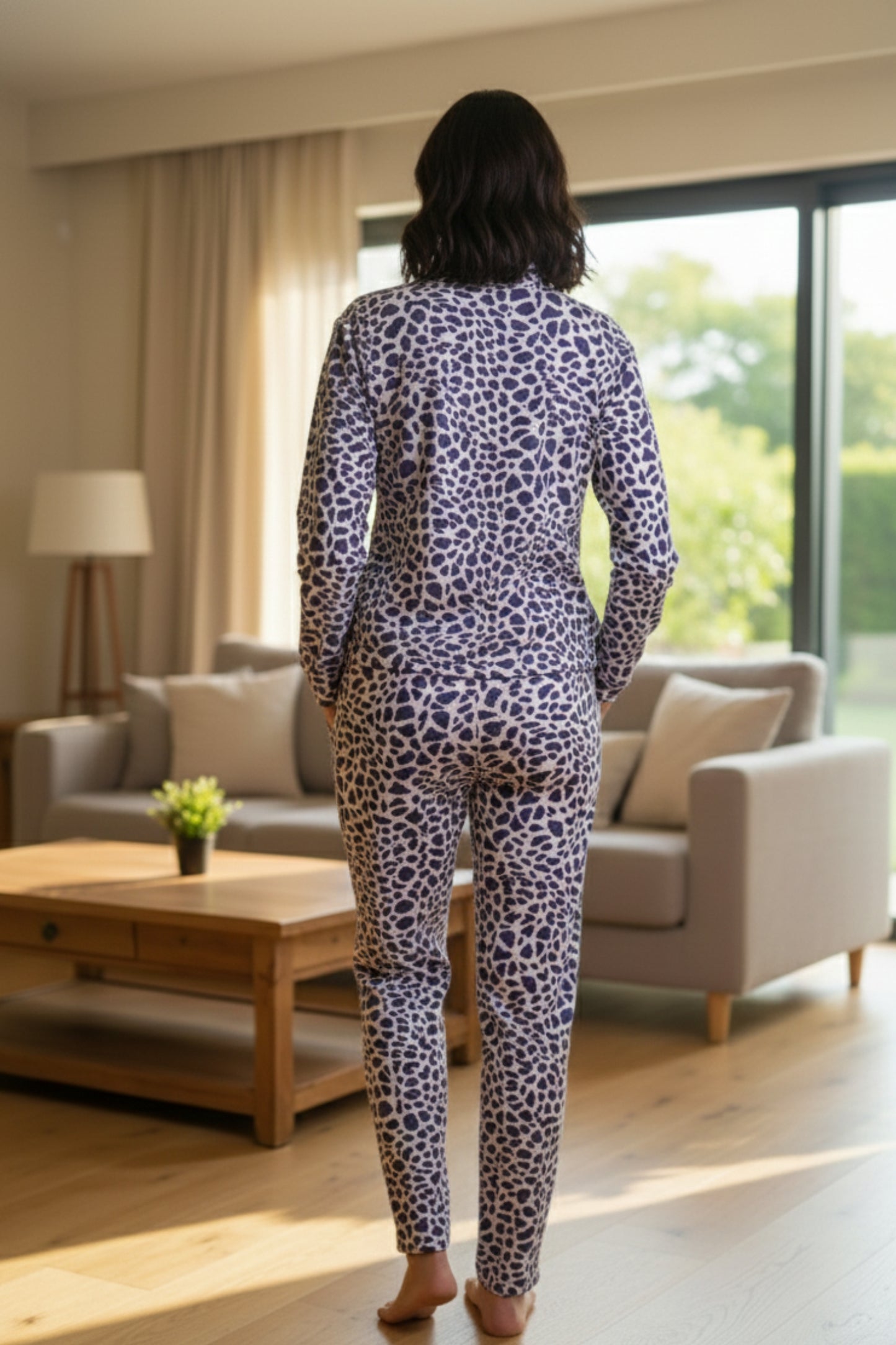 Person wearing a leopard print outfit standing in a living room.