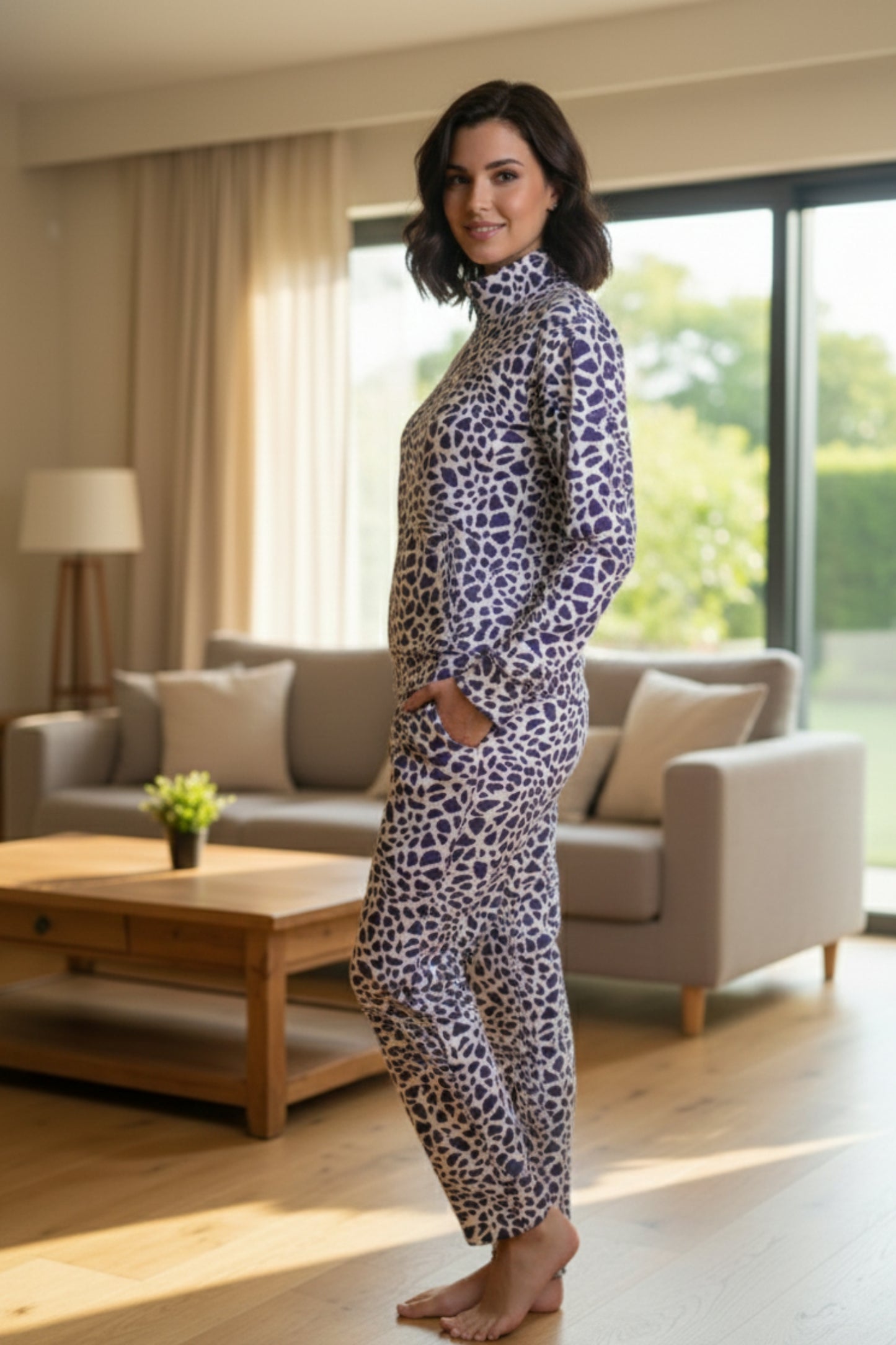 Woman in a leopard print outfit standing in a living room.